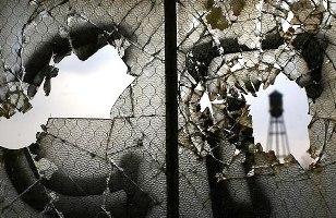 Image: Broken windows are seen inside the abandoned and decaying manufacturing plant of Packard Motor Car in Detroit.