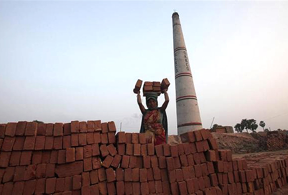A labourer works at a brick factory at Hajipur industrial park on the outskirts of Patna, in Bihar.