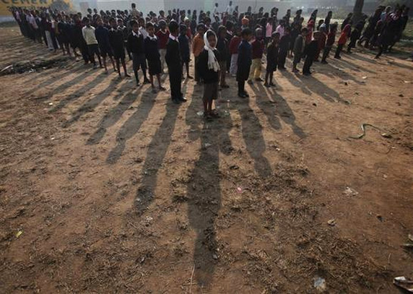 School children stand during the morning prayer at a school in Anandpur near Patna, in Bihar.