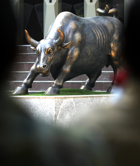 A bronze sculpture of a bull is seen on the premises of the Bombay Stock Exchange.