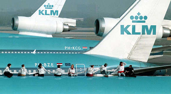 Some of the 13 anti-noise protestors of Milieu Defence, the Dutch arm of Friends of the Earth, sit on a KLM Royal Dutch airliner at Schiphol Airport in Amsterdam, the Netherlands.