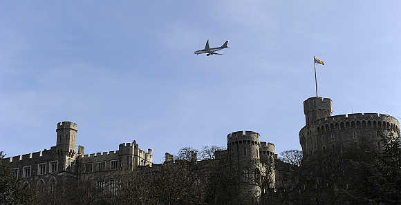 A passenger jet flies over Windsor Castle on its way to Heathrow airport in London.