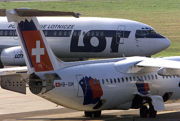 A Polish LOT and SwissAir aircraft pass each other at Okecie airport in Warsaw, Poland.