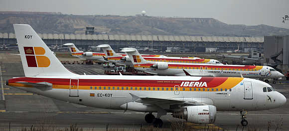 An Iberia passenger plane taxis on the tarmac of Madrid's Barajas airport in Spain.