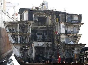 Workers dismantle a decommissioned ship at the Alang shipyard. Photograph: Amit Dave/Reuters