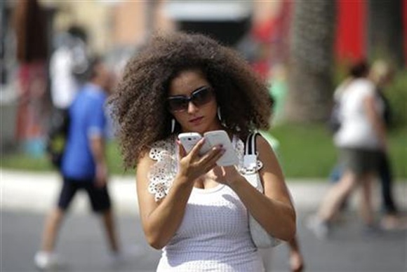 A woman checks her Samsung Galaxy phone.