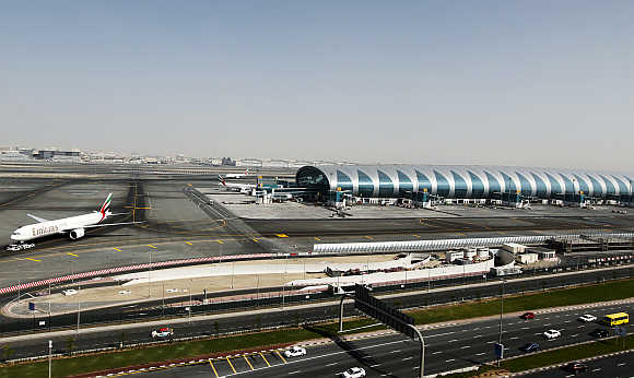 A plane is seen beside the terminal dedicated for A380 aircraft at the concourse in Dubai International Airport.