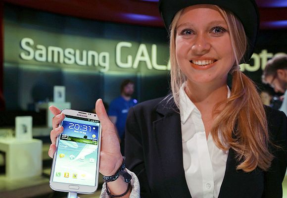 A model poses with the new Samsung Galaxy Note II tablet device during Samsung Mobile Unpacked 2012 event in Berlin.