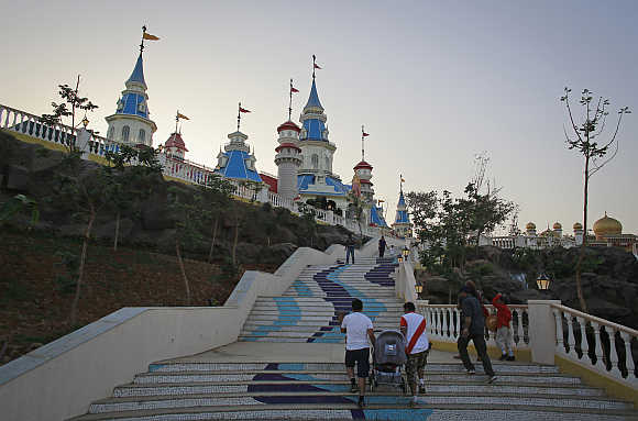 Visitors climb a flight of stairs in Adlabs Imagica theme park.