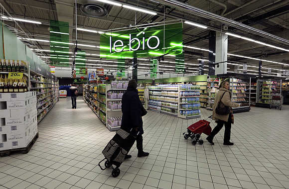 Customers walk past the Bio foods section at Carrefour's Bercy hypermarket in Charenton, a Paris suburb.