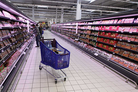 A customer shops at Carrefour Planet supermarket in Nice Lingostiere, France.