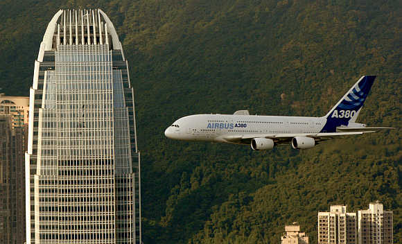 An Airbus A380 flies past International Finance Centre in Hong Kong.