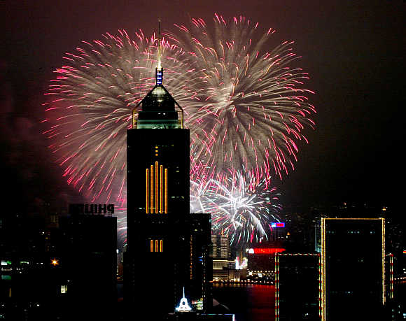 Fireworks explode in front of Central Plaza in Hong Kong.