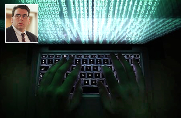 A man types on a computer keyboard in Warsaw in this February 28, 2013 illustration file picture. David Smith (inset)