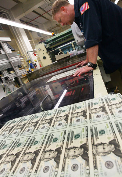 A press is printing twenty dollar US bills at the Bureau of Engraving and Printing in Washington, DC.
