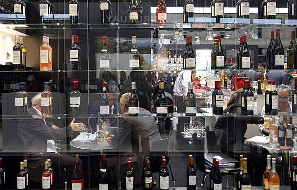 Merchants examine wine as they visit Vinexpo, the world's biggest wine fair, in Bordeaux, southwestern France.