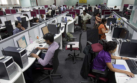 Workers at their workstations on the floor of an outsourcing centre in Bangalore.