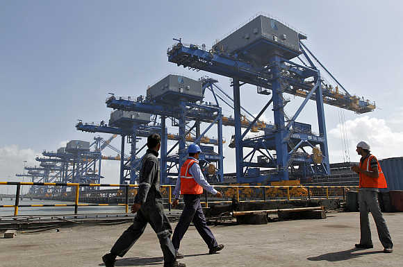 Workers walk past a coal port at Mundra in Gujarat.
