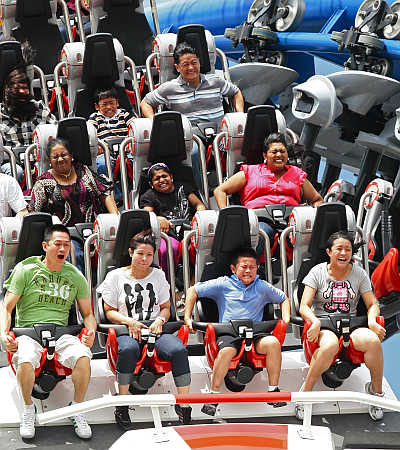 Visitors ride the 'Battlestar Galactica' duelling roller coaster at the Universal Studios theme park in Singapore.