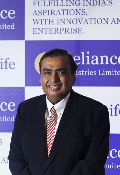 Mukesh Ambani, chairman of Reliance Industries Limited, poses for photographers before addressing the annual shareholders meeting in Mumbai June 6, 2013.
