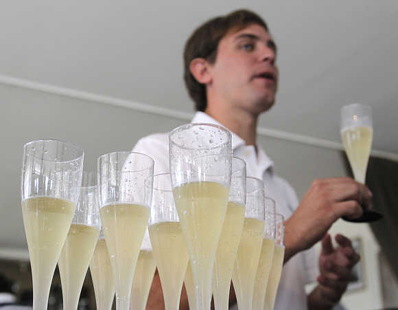 An expert holds a glass of sparkling wine at Casa Bianchi in San Rafael, Argentina.