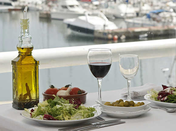 A glass of wine rests on a table at the port of El Masnou, near Barcelona, Spain.