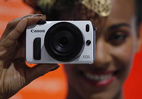 A model presents Canon S110 in Cologne, Germany.