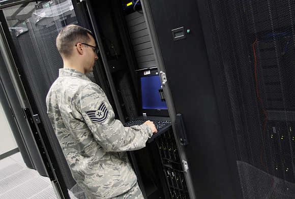 TSgt James Ortiz, shift lead, boundary protection looks over a rack in the server room at the Air Force Space Command Network Operations & Security Center at Peterson Air Force Base in Colorado Springs, Colorado.