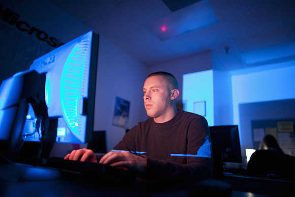 US Marine Sergeant Michael Kidd works on a computer at ECPI University in Virginia Beach, Virginia.