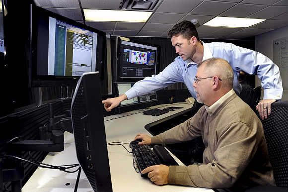 US Department of Homeland Security employees work on the Industrial Control Systems Cyber Emergency Response Team operational watch floor where they monitor, track and investigate cyber incidents at the Idaho National Laboratory in Idaho Falls, Idaho.