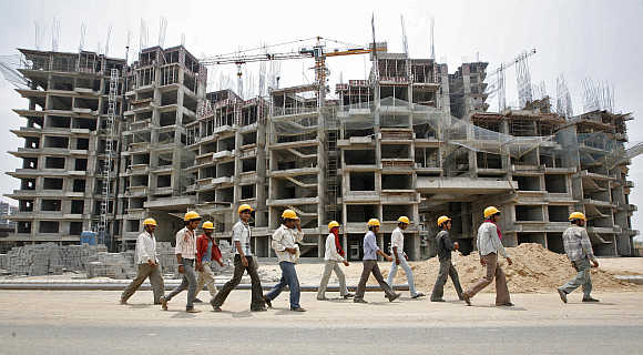 Workers in front of a construction site of a commercial complex on the outskirts of Ahmedabad.