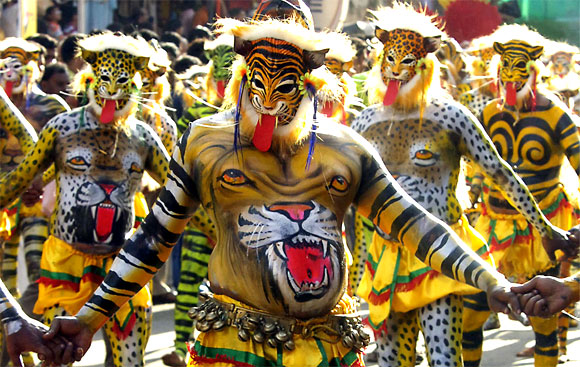 Performers dressed as tigers take part in Pulikali, or tiger dance, during festivities in Trichur city in Kerala.