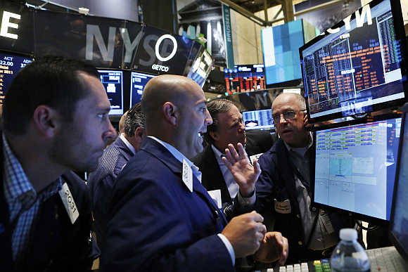 Traders work on the floor at the New York Stock Exchange.