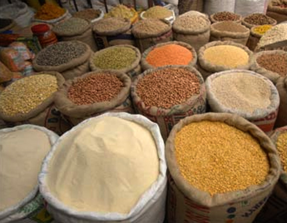 A vendor sells cereals at a grocery shop.