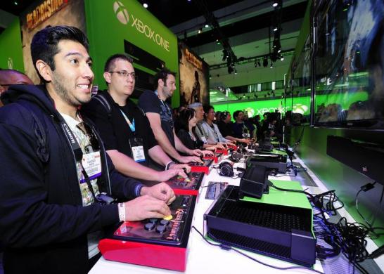 Gamers try out the Xbox One with a third party controller during E3 in Los Angeles, California.