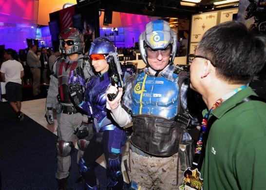 A gamer meets Ever Quest 2 characters during E3 in Los Angeles, California.