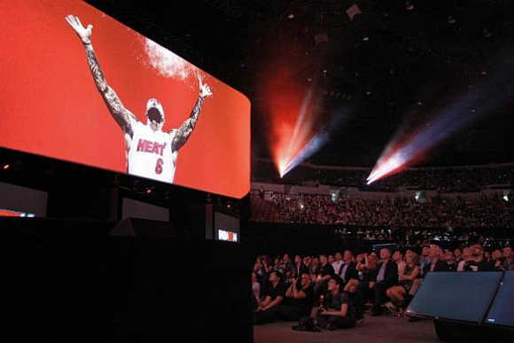 The audience watches Miami Heat star LeBron James in a game demonstration at the Sony news conference show on the eve of the opening of the Electronic Entertainment Expo, in Los Angeles, California.