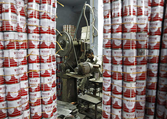 A labourer works inside the tin cans manufacturing unit at a factory in New Delhi.