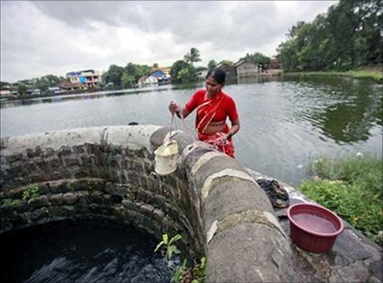 A woman fetches water from a well at Pargoan village, the proposed site of Navi Mumbai airport, about 45 km east of Mumbai.