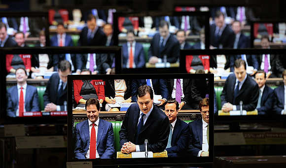 Britain's Chancellor of the Exchequer George Osborne is shown making his budget speech on television screens in an electrical store in Edinburgh, Scotland. A file photo.