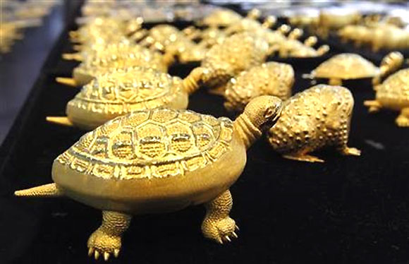 Gold turtles and toads are displayed at a jewellery shop in Seoul.