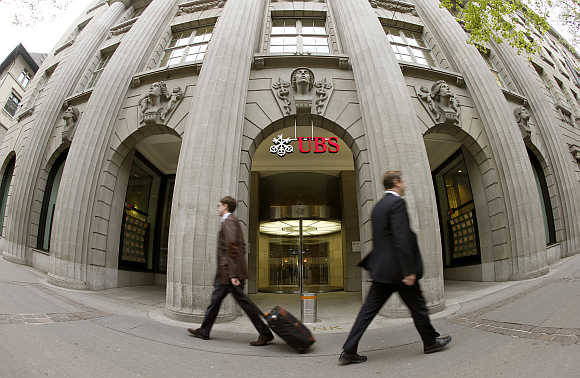 People walk past the headquarters of Swiss bank UBS in Zurich, Switzerland.
