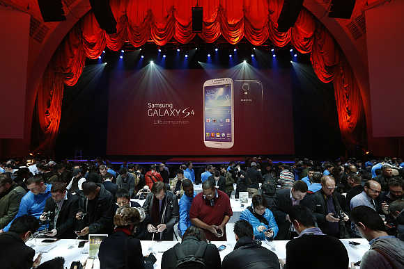 Event goers use Samsung Galaxy S4 smartphone at the Radio City Music Hall in New York.