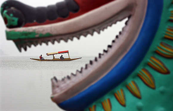 Tourists take a boat ride at Sukhana Lake in Chandigarh.