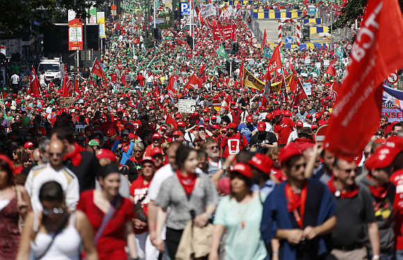 Tens of thousands of public sector workers, employees and trade union members protest against austerity measures during a march through central Brussels in Belgium.