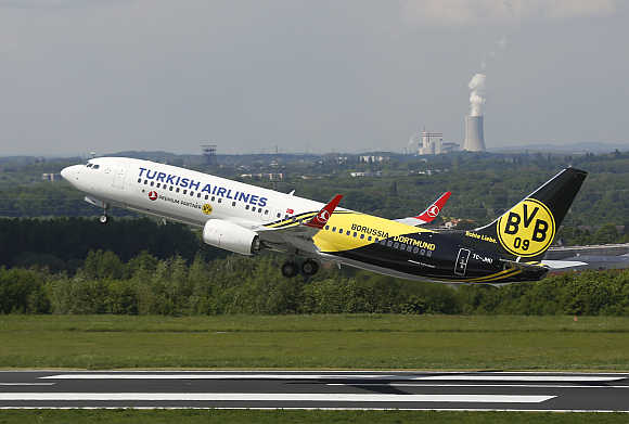 A plane carrying soccer players of Borussia Dortmund, and painted in the clubs colours, takes-off from Dortmund's airport in Germany, on its way to London.