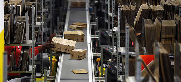 A worker packs boxes at Amazon's logistics centre in Graben near Augsburg, Germany.
