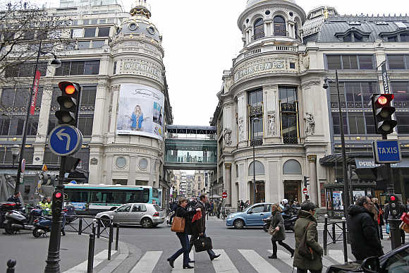 People walk past the Printemps department store in Paris.