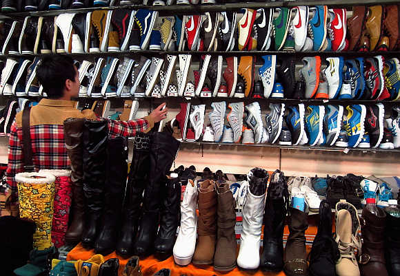 A woman looks at shoes in a market in central Beijing.