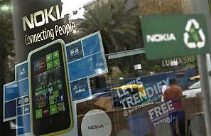 A man is reflected on the glass door of a Nokia showroom in New Delhi. Photograph: Mansi Thapliyal/Reuters